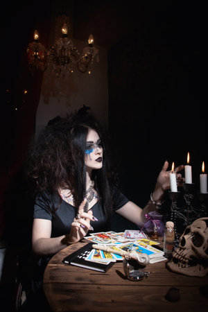 Evil witch conjures in a dark roomの写真素材