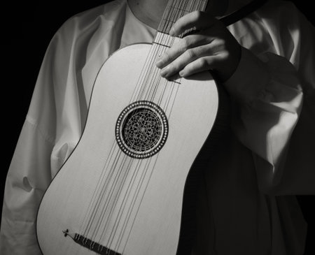 Man playing spanish renaissance instrument vihuela de mano over black 
の写真素材