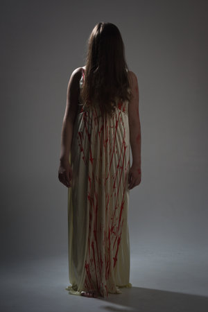 Horror film. A girl in a bloody dressの写真素材