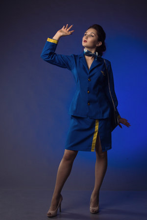 beautiful young pinup girl in suit of stewardessの写真素材