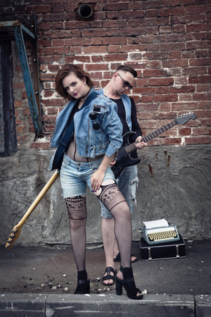 Girl and guy punks on a city streetの写真素材