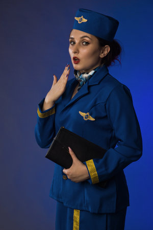 beautiful young pinup girl in suit of stewardessの写真素材