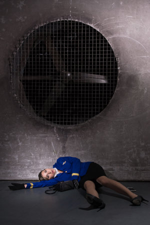 Noir film. Young beautiful flight attendant in uniform being strangled. Not contain any logos or trademark.の写真素材