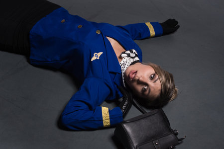 Noir film. Young beautiful flight attendant in uniform being strangled. Not contain any logos or...