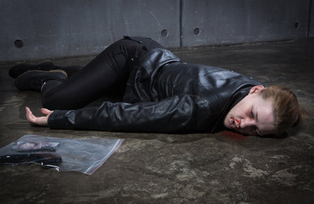 Crime scene imitation. Dead woman lying on a floorの写真素材