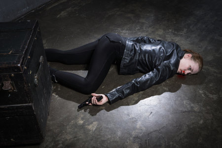Crime scene imitation. Dead woman lying on a floor