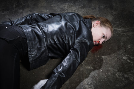 Crime scene imitation. Dead woman lying on a floorの写真素材