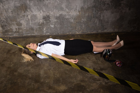 Crime scene imitation. Dead woman police officer lying on a floor