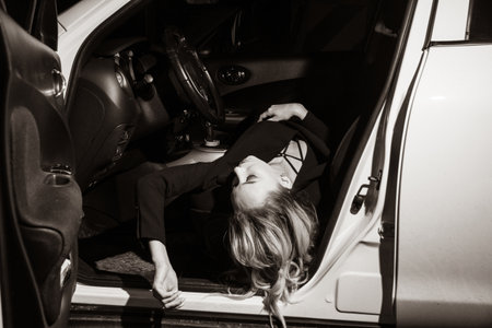 Business woman killed in the car. Crime scene imitation