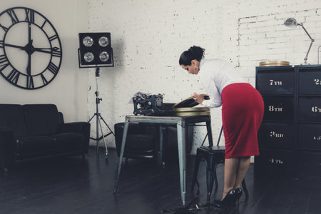 Secretary in the style of Hollywood retro films at the officeの写真素材