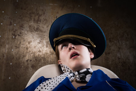 Noir film. Young beautiful flight attendant in uniform being strangled.