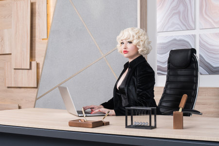 Business woman in the style of Hollywood retro films at the office.の写真素材
