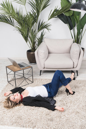 Crime scene with strangled pretty business woman in officeの写真素材