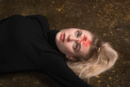 Hit woman. Woman in a black killed in gunfire shot in the headの写真素材