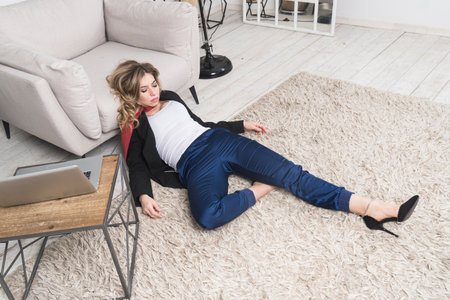 Crime scene with strangled pretty business woman in officeの写真素材