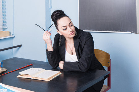 Beautiful confident teacher in a classroom.の写真素材