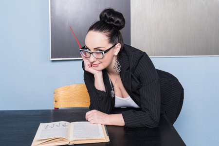 Beautiful confident teacher in a classroom.の写真素材