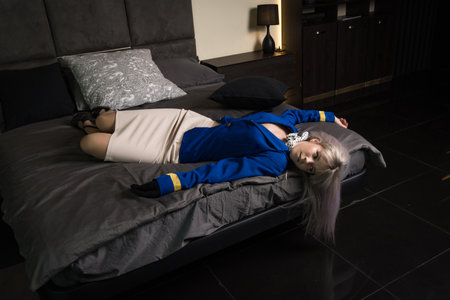 Noir film. Young beautiful flight attendant in uniform being strangled.の写真素材