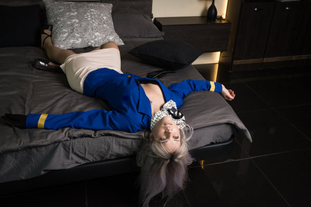 Noir film. Young beautiful flight attendant in uniform being strangled.の写真素材