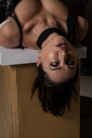 Strangled beautiful woman lying on the floor. Simulation of the crime scene.の写真素材