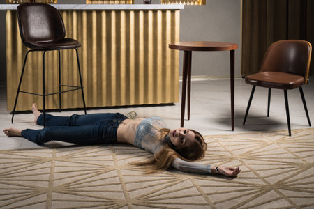 Crime scene imitation. Dead woman lying on a floor.の写真素材