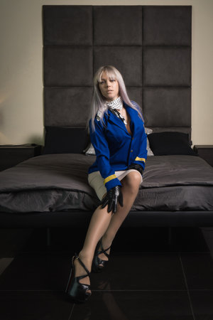 Beautiful young pinup girl in suit of stewardessの写真素材