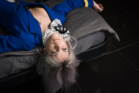 Noir film. Young beautiful flight attendant in uniform being strangled.の写真素材