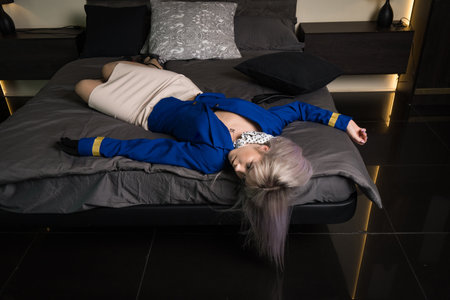 Noir film. Young beautiful flight attendant in uniform being strangled.の写真素材