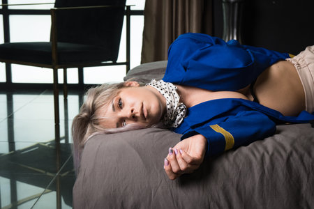 Noir film. Young beautiful flight attendant in uniform being strangledの写真素材