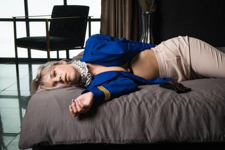 Noir film. Young beautiful flight attendant in uniform being strangled.の写真素材