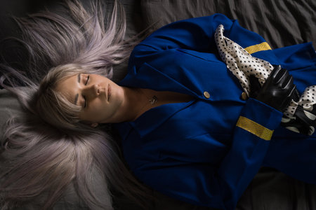 Noir film. Young beautiful flight attendant in uniform being strangled.の写真素材