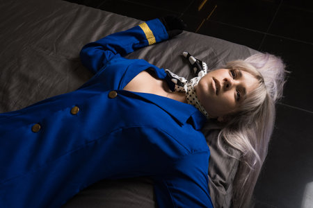 Noir film. Young beautiful flight attendant in uniform being strangled.の写真素材