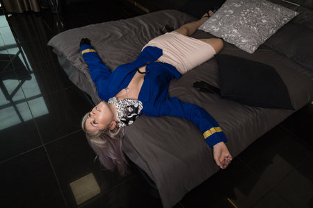 Noir film. Young beautiful flight attendant in uniform being strangled.の写真素材