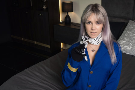 Beautiful young pinup girl in suit of stewardessの写真素材