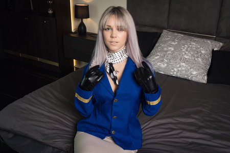 Beautiful young pinup girl in suit of stewardessの写真素材