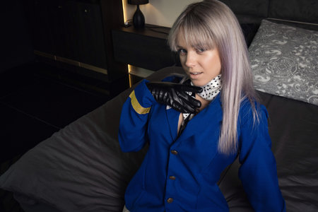 Beautiful young pinup girl in suit of stewardessの写真素材