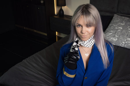 Beautiful young pinup girl in suit of stewardessの写真素材