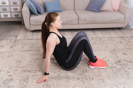 Beautiful woman stretching the muscles of her legsの写真素材