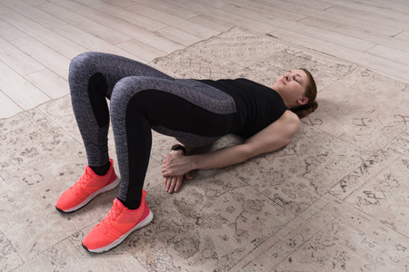 Beautiful woman stretching the muscles of her legsの写真素材