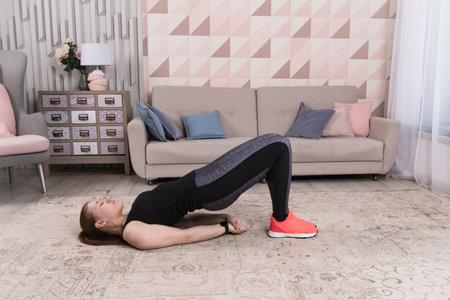 Beautiful woman stretching the muscles of her legsの写真素材