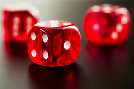 detail of three red dice on black background