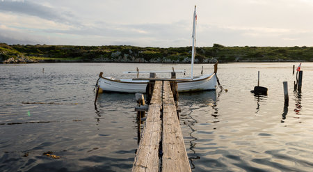 Traditional fishing boats and gangway at sunset on summer day, Menorca, Balearic islands, Spain,の写真素材