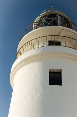 Traditional white light house in a sunny day in Cap Cavaller?a, Menorca, Balearic Islands, Spain.の写真素材