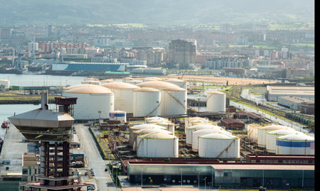 Fuel and Oil Tanks in the Petrochemical Industry in daylight. City of Gijon at background.のeditorial素材