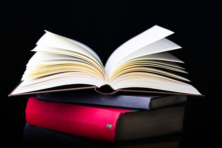Flying several books isolated on black background.