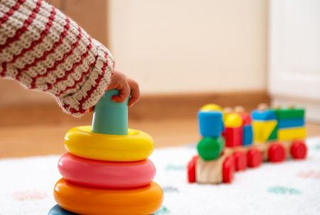 Close-up of a BabyÂ´s Hand, Playing with a Colorful Toy. Unfocused Backgroundの写真素材