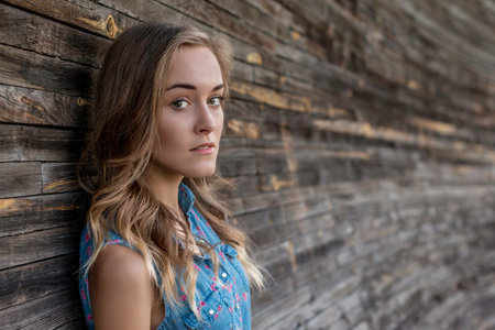 girl in a dress near the wooden wallの写真素材