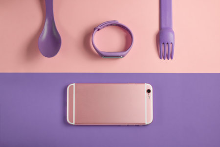 flat lay fitness set with phone, tracker, spoon and forkの写真素材