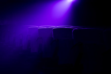 Cinema  theater seats with projection light falling into the lensの写真素材