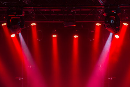 A view from above of the ceiling of a concert stage with  red  and white spotlights on a Stage farmの写真素材